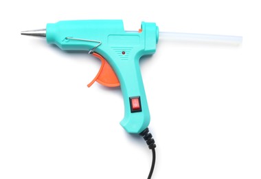 Photo of Turquoise glue gun with stick isolated on white, top view