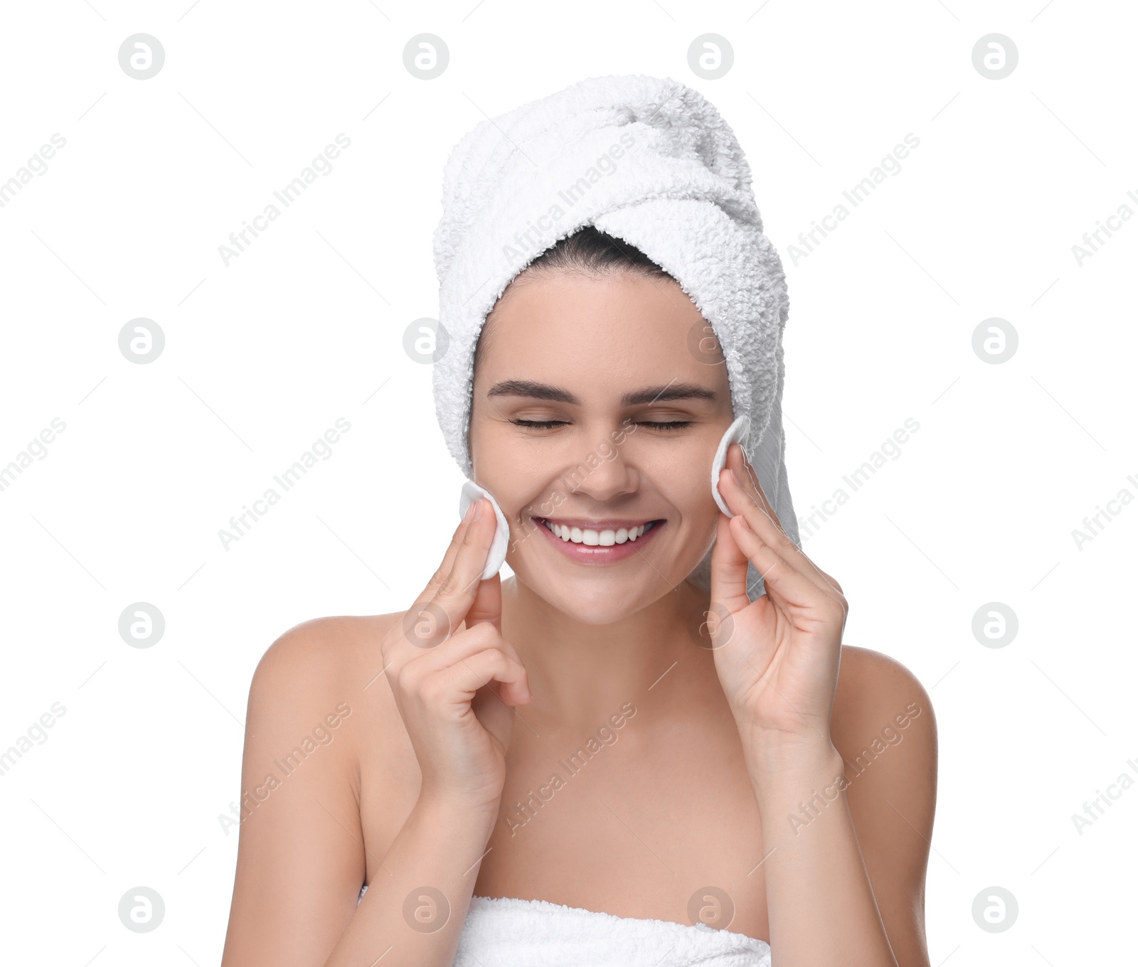 Photo of Young woman cleaning her face with cotton pads on white background