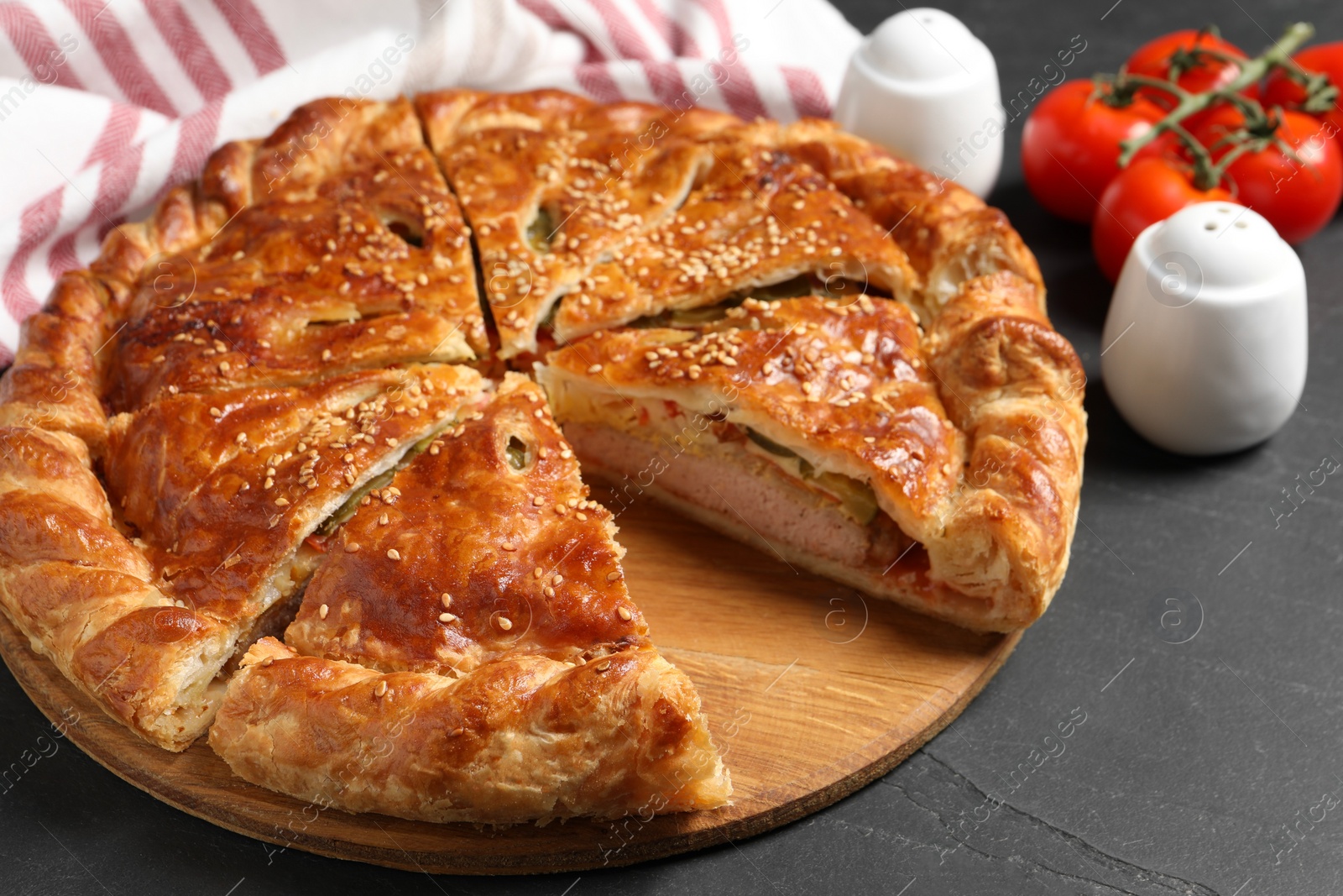 Photo of Cut delicious homemade pie on black table