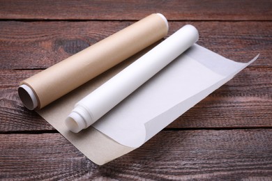 Photo of Rolls of baking paper on wooden table