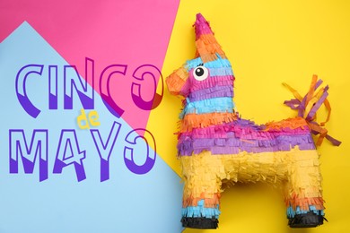 Image of Cinco de Mayo festive poster. Bright funny pinata on color background, top view