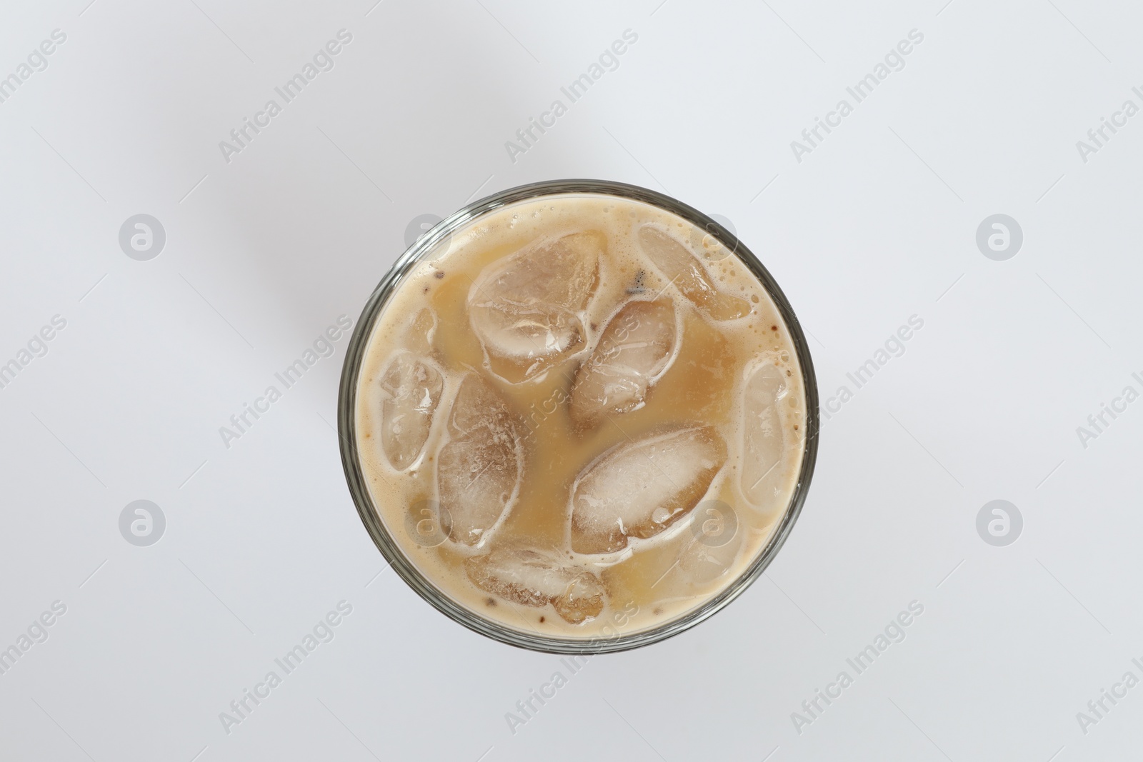 Photo of Iced coffee in glass on white background, top view