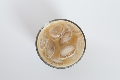 Photo of Iced coffee in glass on white background, top view