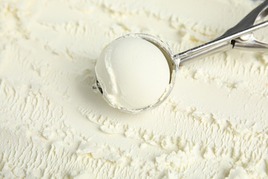 Photo of Scoop with delicious vanilla ice cream, closeup