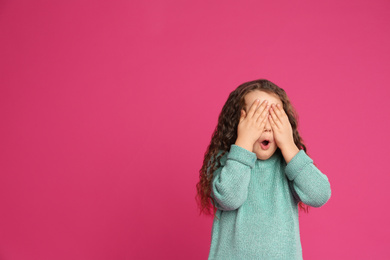Photo of Portrait of cute little girl on pink background. Space for text