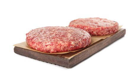 Photo of Raw hamburger patties and wooden board on white background