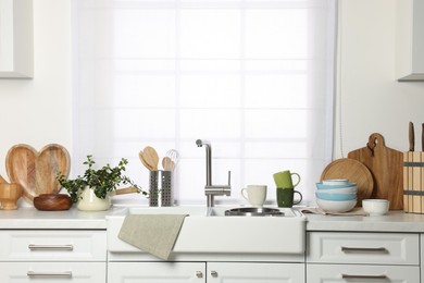 Photo of Countertop with sink and cooking utensils in kitchen