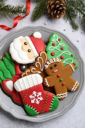 Photo of Tasty homemade Christmas cookies and decor on light grey table, flat lay