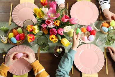 Photo of Festive table setting. Women celebrating Easter at home, top view