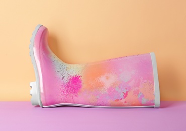 Photo of Gumboot on color background. Female shoes