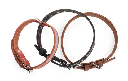 Photo of Different leather dog collars on white background, top view