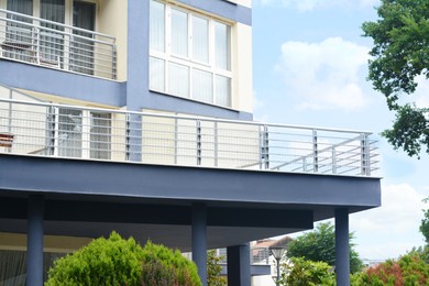 Photo of Exterior of beautiful building with balconies against blue sky