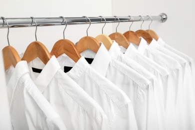 Rack with clean clothes after dry-cleaning on hangers