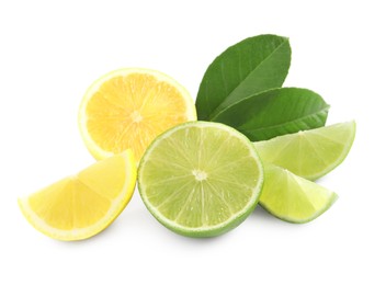 Photo of Cut fresh ripe lemon, lime and green leaves on white background