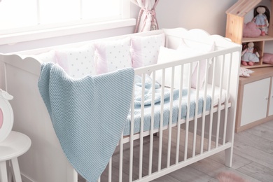Photo of Baby room interior with comfortable crib