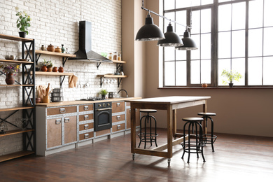 Photo of Beautiful kitchen interior with new modern oven and stylish furniture