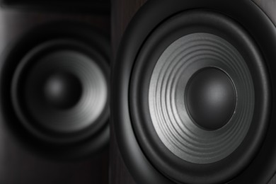 Photo of Two modern sound speakers as background, closeup