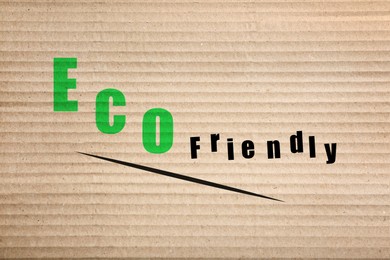 Image of Phrase Eco Friendly written on cardboard, top view