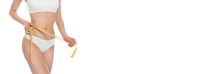 Closeup view of slim woman in underwear with measuring tape on white background. Banner design