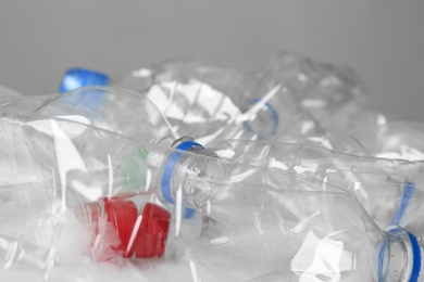 Photo of Many used plastic bottles against light background, closeup. Recycle concept