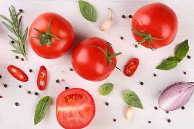 Photo of Flat lay composition with whole and cut tomatoes on white wooden table
