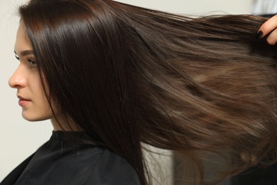 Photo of Hairdresser working with client in beauty salon