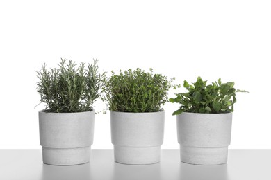 Photo of Pots with thyme, mint and rosemary on white background