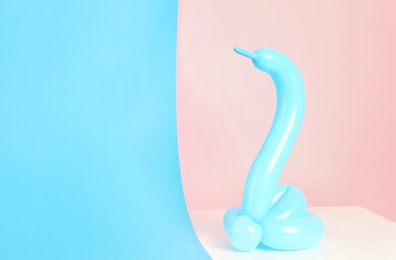Photo of Snake figure made of modelling balloon on color background. Space for text