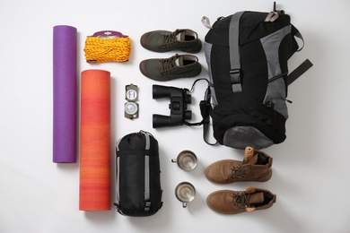 Photo of Flat lay composition with camping equipment on white background