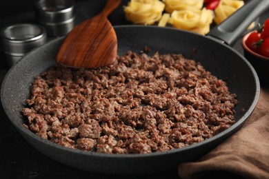 Photo of Fried minced meat on black table, closeup