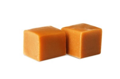 Photo of Two sweet caramel candies on white background
