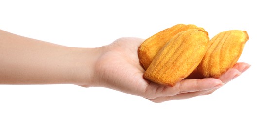 Photo of Woman holding delicious madeleine cakes on white background, closeup