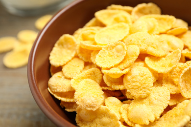 Photo of Tasty crispy corn flakes in bowl, closeup