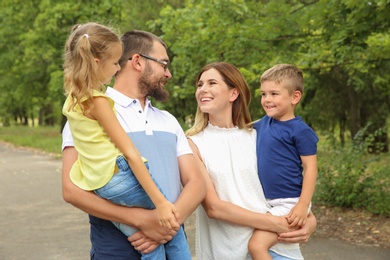 Photo of Happy family spending time together with their children outdoors