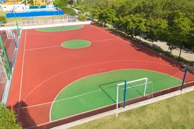 Image of Aerial view of football pitch on sunny day