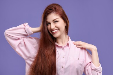 Photo of Portrait of smiling woman on purple background