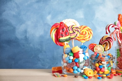 Photo of Composition with many different candies on table. Space for text
