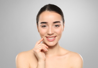 Photo of Portrait of young woman with beautiful face against color background