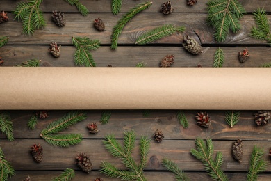 Photo of Flat lay composition with pinecones and blank card on wooden background, space for text