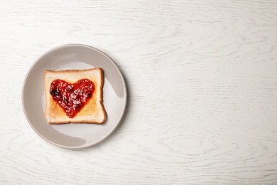 Photo of Toast with jam on wooden background, top view