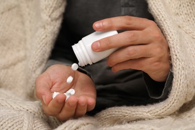 Photo of Man pouring antidepressants from bottle, closeup view
