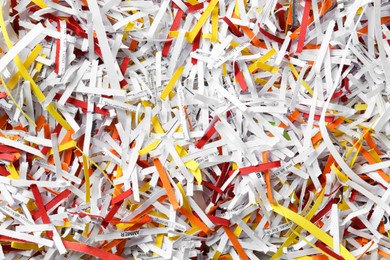 Photo of Heap of shredded colorful paper strips as background, top view