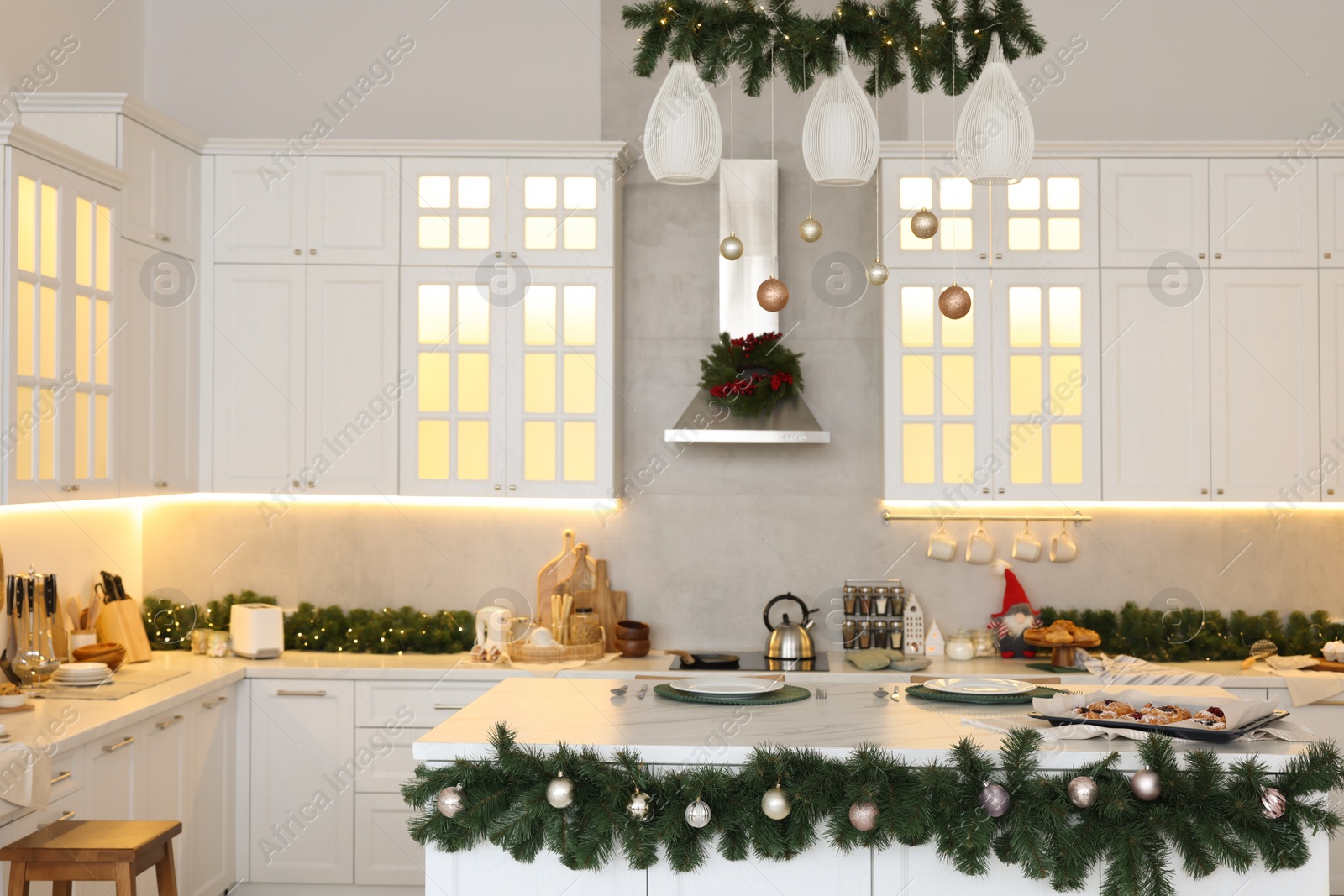 Photo of Cozy spacious kitchen decorated for Christmas. Interior design