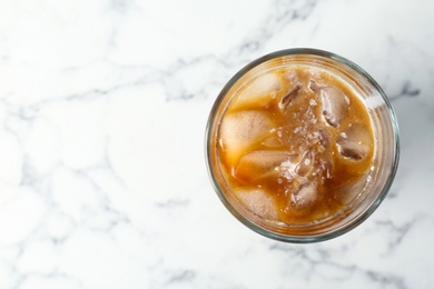 Glass with cold brew coffee and milk on light background