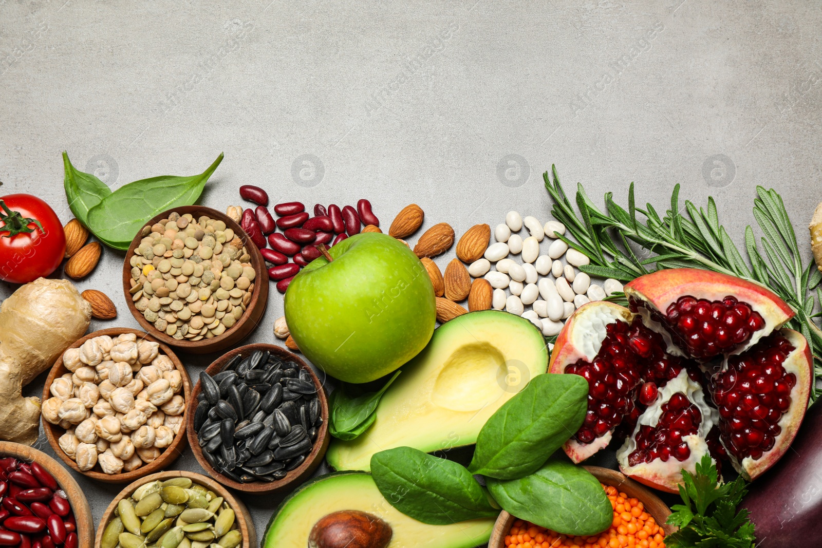 Photo of Flat lay composition with different vegetables, seeds and fruits on grey table, space for text. Healthy diet