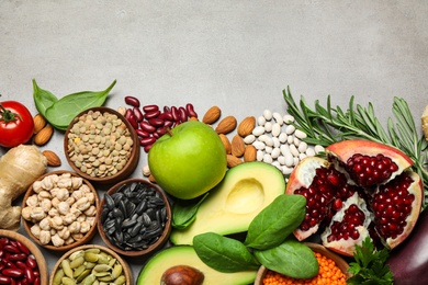 Photo of Flat lay composition with different vegetables, seeds and fruits on grey table, space for text. Healthy diet