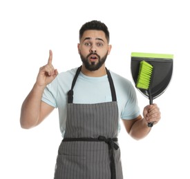 Photo of Emotional young man with brush and dustpan on white background