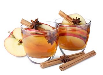 Hot mulled cider and ingredients on white background