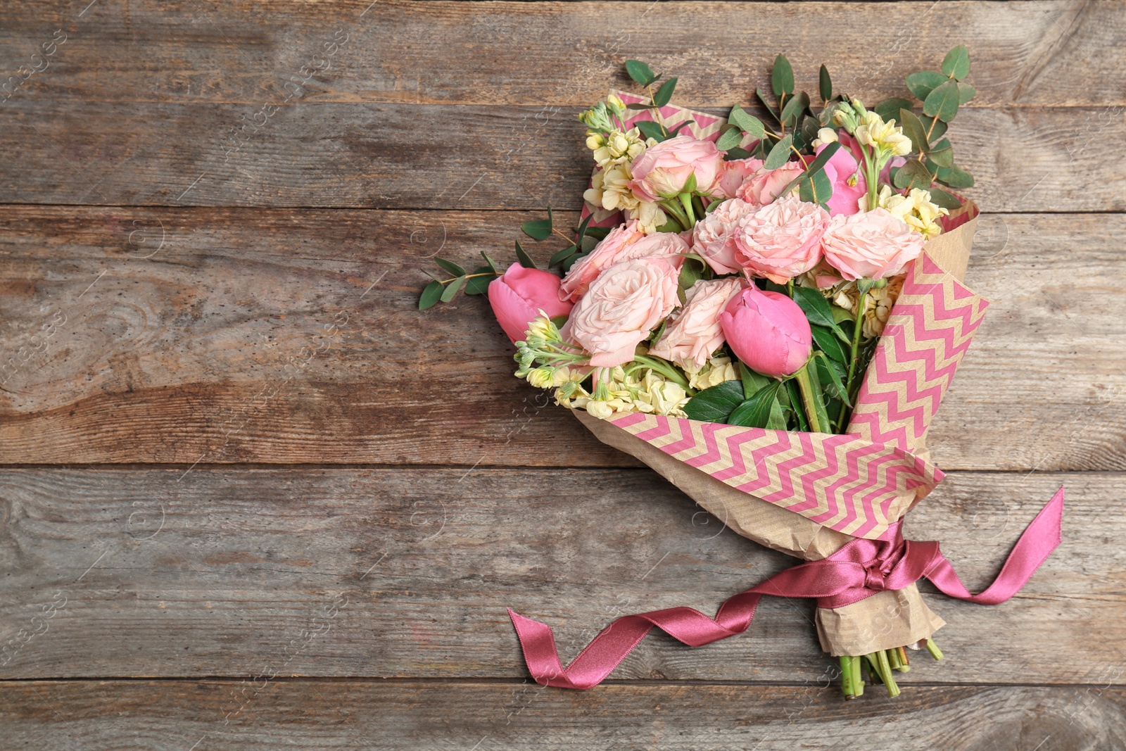 Photo of Bouquet of beautiful fragrant flowers on wooden background