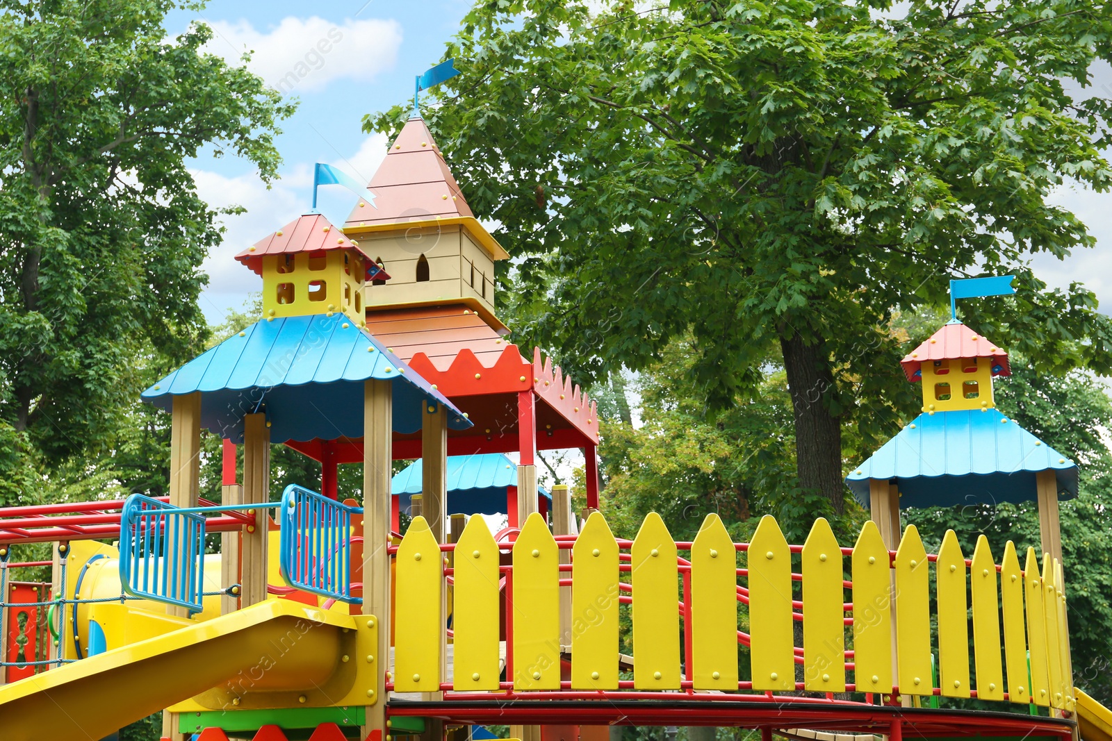 Photo of New colorful castle playhouse with slide on children's playground